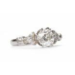 IMPRESSIVE DIAMOND DRESS RING set with a central round brilliant cut diamond of approximately 0.