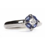 PLATINUM SAPPHIRE AND DIAMOND RING the central round brilliant cut diamond surrounded by sapphires,