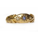 VICTORIAN SAPPHIRE AND DIAMOND RING with a star set sapphire flanked by two star set diamonds,