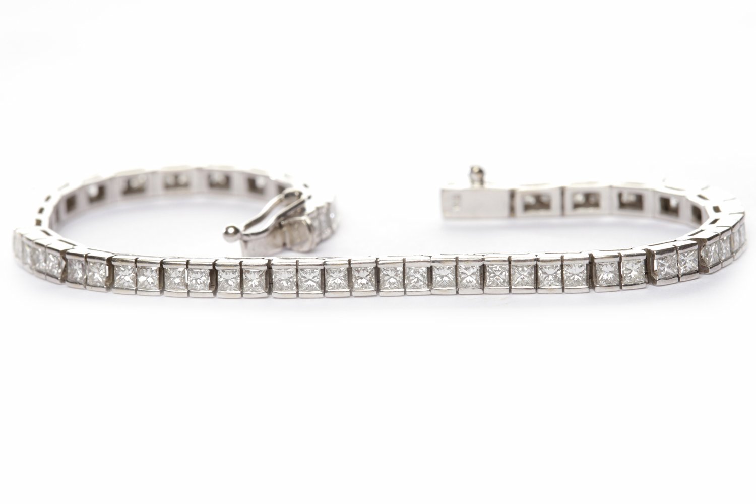 EIGHTEEN CARAT WHITE GOLD DIAMOND LINE BRACELET set with princess cut diamonds totalling