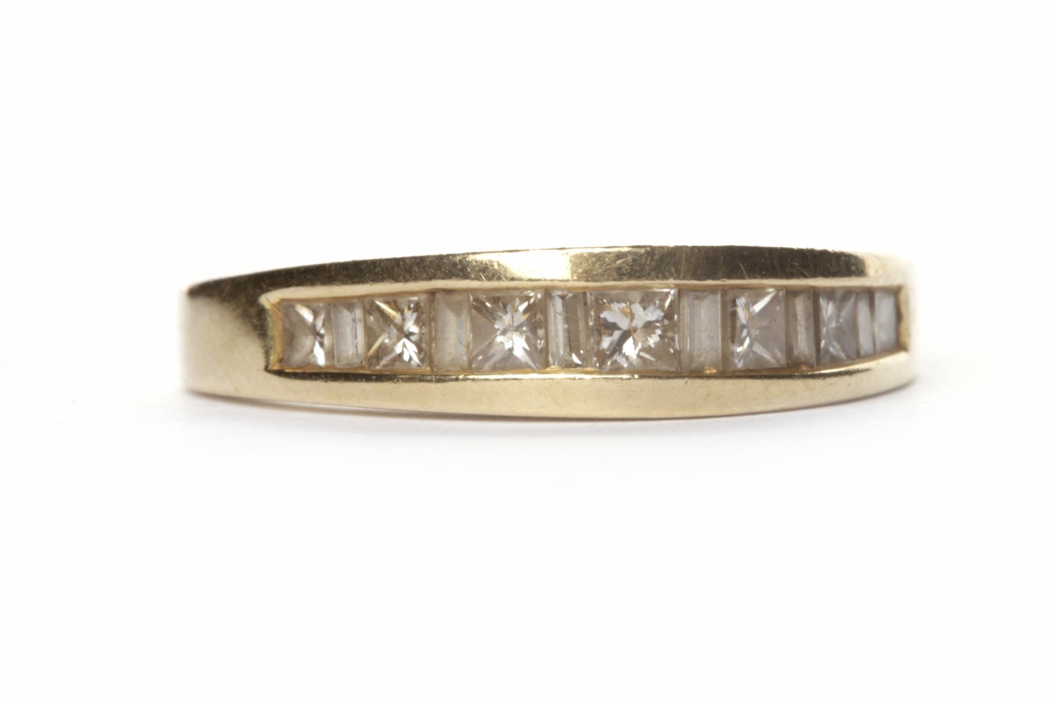 DIAMOND SET BAND with channel set with baguette and princess cut diamonds, in eighteen carat gold,