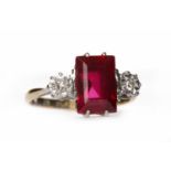 CREATED RUBY AND DIAMOND THREE STONE RING the central rectangular step cut created ruby flanked by