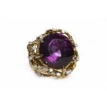 IMPRESSIVE 1970S AMETHYST AND DIAMOND DRESS RING set with a large round faceted amethyst