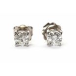 PAIR OF EIGHTEEN CARAT WHITE GOLD DIAMOND SINGLE STONE EARRINGS each set with a round brilliant cut