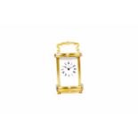 MAPPIN & WEBB BRASS CASED CARRIAGE CLOCK of serpentine outline, the enamel dial with Roman numerals,