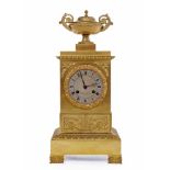 19TH CENTURY FRENCH GILTMETAL MANTEL CLOCK OF EMPIRE DESIGN the stepped cornice with urn finial,