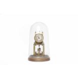 BRASS ANNIVERSARY CLOCK the silvered dial with Arabic numerals, with swivel weights,