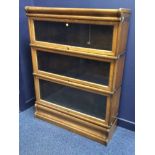 GLOBE WERNICKE OAK THREE SECTION STACKED BOOKCASE enclosed by three sliding glazed doors on a box