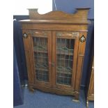 ARTS & CRAFTS OAK DWARF BOOKCASE the shaped back with adjustable shelving below enclosed by two