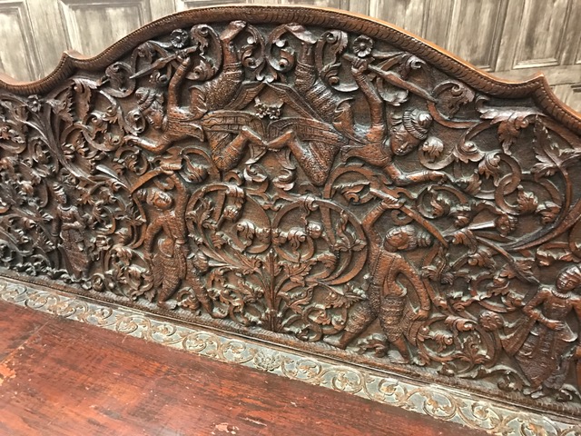 LATE VICTORIAN CARVED OAK HALL SETTLE IN THE ANGLO-INDIAN MANNER the shaped arched back panel - Image 2 of 3