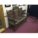 19TH CENTURY CARVED OAK HALL SETTLE the arched back with carved panels in the manner of revivalist