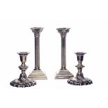 PAIR OF SILVER PLATED CORINTHIAN COLUMN CANDLESTICKS each with stepped square base,