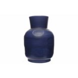 SUSIE COOPER VASE with flared neck and of ribbed oviform, in deep blue with impressed circle motifs,