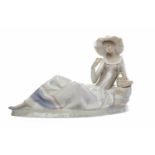 NAO RECLINING FEMALE FIGURE IN COUNTRY DRESS modelled as a woman holding a basket,
