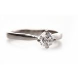 PLATINUM DIAMOND SOLITAIRE RING with a round brilliant cut stone of approximately 0.