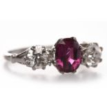 DIAMOND AND RUBY THREE STONE RING set with a central oval ruby of approximately 1.