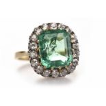 IMPRESSIVE EMERALD AND DIAMOND DRESS RING set with a central cushion shaped emerald 11.8x10.1x5.