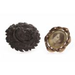 TWO VICTORIAN BROOCHES comprising one carved jet example,