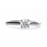 CARTIER GIA CERTIFICATED DIAMOND SOLITAIRE RING with a four claw set round brilliant cut diamond of