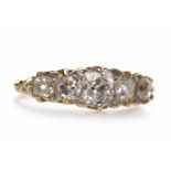 VICTORIAN STYLE DIAMOND FIVE STONE RING with a boat shaped bezel with pierced gallery and engraved