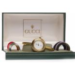 LADY'S GUCCI BANGLE QUARTZ WRIST WATCH the round white dial lacking numerals,