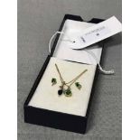 DIOPSIDE AND DIAMOND GOLD PENDANT AND EARRINGS along with a sapphire and diamond pendant on a gold