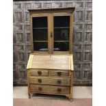 OAK BUREAU BOOKCASE OF ARTS AND CRAFTS DESIGN the raised back with adjustable shelving enclosed by