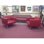 PAUL SMITH DESIGN RED LEATHER SETTEE AND TWO RED LEATHER ARMCHAIRS the settee with striped fabric