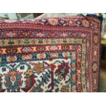 ROYAL KESHAN BORDERED CARPET decorated with large central medallion within a floral field,