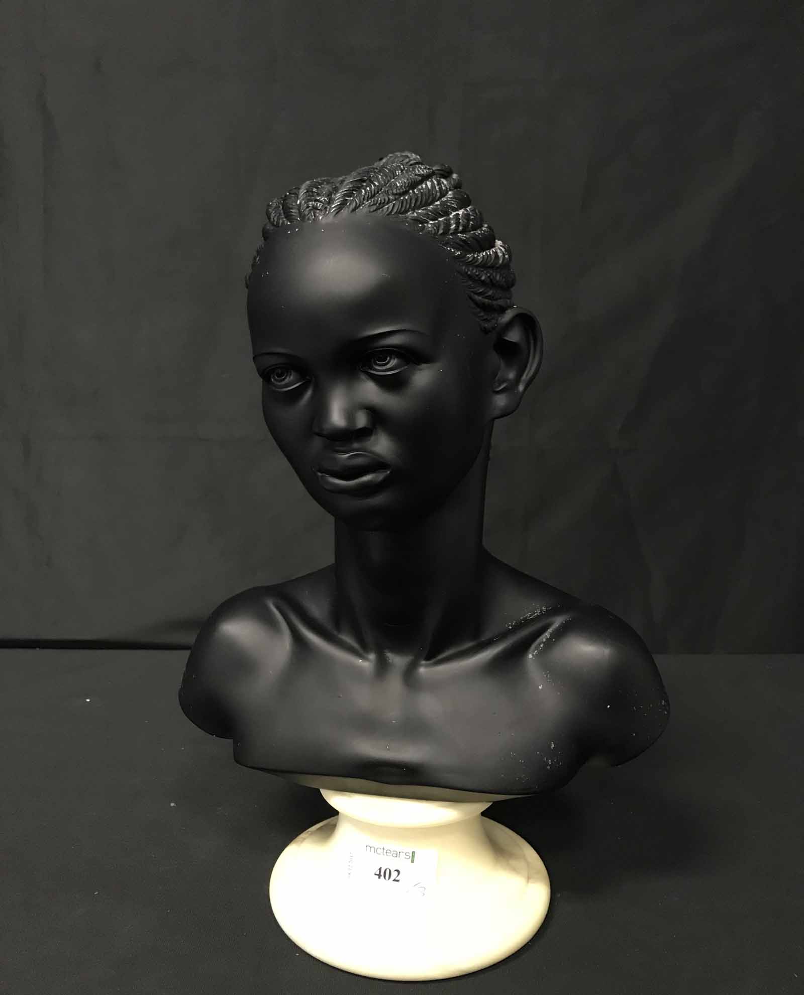 PLASTER BUST OF A FEMALE along with two African wooden bookends