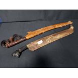 SARAWAK SWORD with carved wooded handle and sheath,