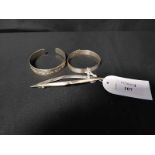 TWO SILVER BANGLES and a silver lozenge shaped brooch (3)