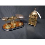 BRASS MINIATURE LANTERN-TYPE CLOCK along with a set of brass and wood postal scales with weights