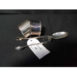 TWO SILVER NAPKIN RINGS also a silver teaspoon,