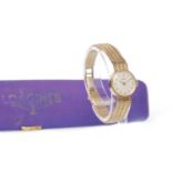 LADY'S LONGINES NINE CARAT GOLD MANUAL WIND WRIST WATCH the round cream dial with applied baton and