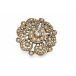 EDWARDIAN DIAMOND AND SPLIT PEARL SET BROOCH of circular form, pierced,