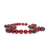 EARLY TWENTIETH CENTURY BAKELITE BEAD NECKLACE formed by spherical red beads,