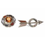 TWO VICTORIAN SCOTTISH BROOCHES one of scalloped circular form and set with a single orange paste