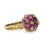 VICTORIAN EIGHTEEN CARAT GOLD RUBY AND DIAMOND RING the floral motif bezel set with pear shaped