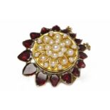 NINETEENTH CENTURY GARNET AND SPLIT PEARL PENDANT formed by late Victorian central circular split