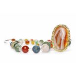 VICTORIAN BANDED AGATE BROOCH of oval form, with a central section of orange and white banded agate,