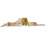 FRENCH EARLY TWENTIETH CENTURY GILT BRACELET with a section of larger faux pearls and overlaid