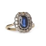 EDWARDIAN SAPPHIRE AND DIAMOND DRESS RING the central oval sapphire 8mm and surrounded by round