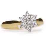 DIAMOND CLUSTER RING the diamond daisy cluster bezel formed by round brilliant cut stones totalling