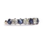 SAPPHIRE AND DIAMOND SEVEN STONE RING set with round brilliant cut diamonds totalling approximately