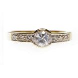 NINE CARAT GOLD CZ DRESS RING set with a central round CZ and on CZ set shoulders, size N, 2.