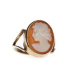 CAMEO SET RING set with an oval shell cameo carved to depict a female in profile facing left,
