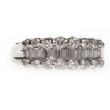 DIAMOND DRESS RING with a central row of channel set baguette cut diamonds flanked by two rows of