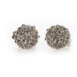 PAIR OF DIAMOND CLUSTER EARRINGS each set with round diamonds in a daisy cluster, 7mm across,