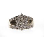 NINE CARAT GOLD DIAMOND CLUSTER RING with an elliptical bezel set with round diamonds set to a